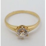 A yellow metal ring set with white stone CONDITION: Please Note - we do not make