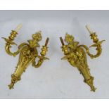 A pair of gilded bronze twin branch wall lights with acanthus harebell etc decoration.