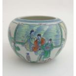A Chinese Famille Verte vase depicting officials in a pagoda garden scene with Chinese motif to the