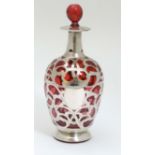 A cranberry glass bottle with silver overlay hallmarked Birmingham 1901 maker Henry Herbert Friend.