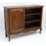 An early 20thC Louise XV style oak bookcase,