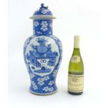 A Chinese blue and white foo dog lidded vase of baluster form with oriental cherry / prunus blossom
