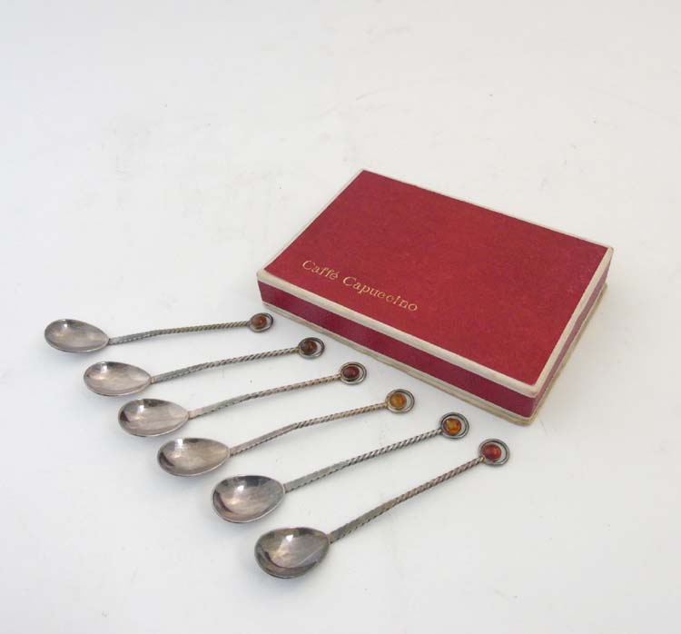 A Boxed set of 6 silver plate mocha spoons with amber cabochon. Marked K MET W.