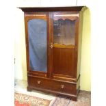 Arts and Crafts : A mahogany and brass strapped double wardrobe with single bevelled mirror and