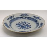 A blue and white Chinese ceramic plate. Decorated with flora in central well and border.