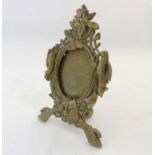 A Victorian easel / strut photograph frame having cast bass relief of gun dog head and horn over