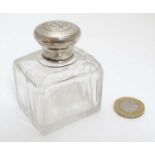 A glass perfume / scent bottle with French silver top having engine turned decoration .