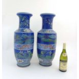 A pair of Chinese rouleau vases decorated with polychrome enamels,