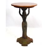 A mid - late 20thC pedestal table with cast iron column in the form of an Egyptian figure with