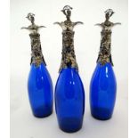 Three grape and vine blue glass decanters/carafe. 21st C.