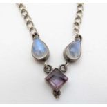 A silver necklace set with moonstone and amethyst detail.