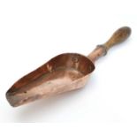 A Victorian copper scoop / measure with turned wooden handle. Possibly a sweet shop scoop.