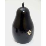 A 21stC novelty tea caddy formed as an ebonised pear.