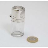 A silver glass salts bottle of cylindrical form with silver top hallmarked Birmingham 1913 maker