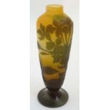 A cameo glass vase, the orange ground with pale brown floral clematis like detail .