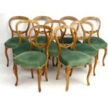 A set of 9 ( 8+1) Victorian blonde walnut overstuffed balloon back dining chairs.