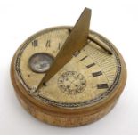 A Chinese wooden folding circular pocket sun dial with inset compass signed in Chinese with Chinese