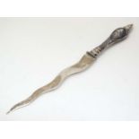 A silver paper knife with damascene decorated handle.