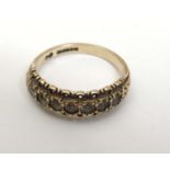 A 9ct gold ring set with 7 white stones in a linear setting CONDITION: Please