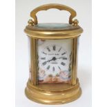 An cylindrical brass miniature Carriage clock : a 21 st C enamel and brass small brass cased