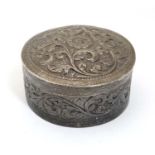 A white metal small box of circular form with acanthus scroll decorated.