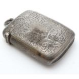 A silver vesta case with engraved fruiting vine decoration.