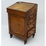 A mid 19thC pollarded oak Davenport with pull-out pen drawer,