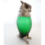 A novelty claret jug formed as an owl, having a green glass body,