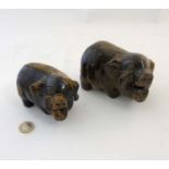 Two carved Tigers Eye hard stone Oriental figures formed as Potbellied pigs .