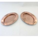 Arts & Crafts : A pair of oval embossed copper trays,