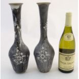 A pair of Continental drip enamel decorated turned metal bottle vases.