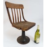 An early 20thC children's lathe back Chair standing on a engraved iron base marked 'KENNEY BROS &
