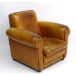 An Art Deco tan leather upholstered club armchair with scroll arms 35" high CONDITION: