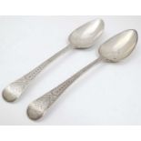 A pair of Geo III table spoons with engraved bright cut decoration.