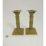 Ornate 19 th Candlesticks : a pair of circa 1890 brass reeded column candlesticks with Corinthian