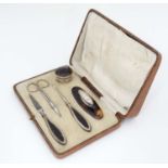 A cased manicure set including file, buffer,