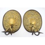 A pair of ornate embossed brass and wooden 2-branch wall lights 16 3/4" high x 13 1/2" wide