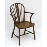 An early 19thC ash and elm Windsor chair with pierced wheatsheaf back splat,