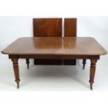 A Gillows mahogany extending dining table with unusual action,