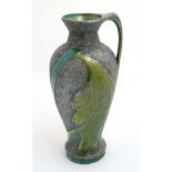 An Austrian Aesthetic movement ewer having green iridescent stylised wing decoration on a grey