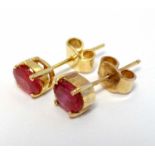 A pair of gilt metal stud earrings set with red stones CONDITION: Please Note - we