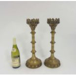A pair of Gothic decorated pricket stands with circular bases standing 18 3/4" high