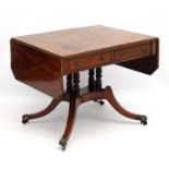 A late Regency mahogany Sofa / Library Table with rosewood cross banding,