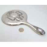 A silver hand mirror hallmarked Birmingham 1915 maker Henry Matthews.