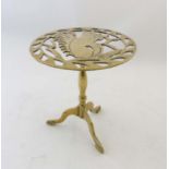 A Victorian style brass trivet with pierced squirrel decoration and triform foot.