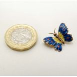 A gold brooch formed as a butterfly with enamel decoration. Marked Italy 18k.