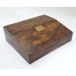 A 19 thC walnut writing slope / box with brass fittings and squared escutcheon,