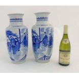 A pair of blue and white Chinese vases of baluster form depicting imperials in pagoda garden scene,