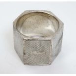 A hexagonal formed napkin ring with engine turned decoration hallmarked Birmingham 1947.