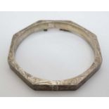 A silver bracelet of bangle form with engraved acanthus scroll decoration CONDITION: